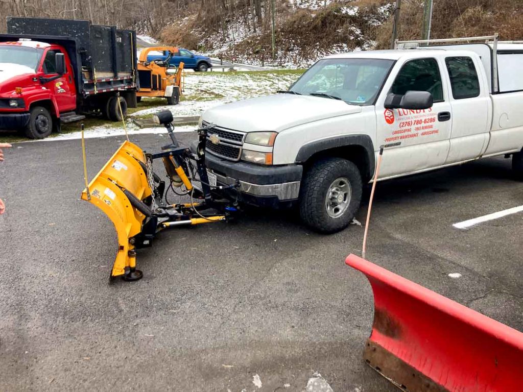 Snow plowing vehicle